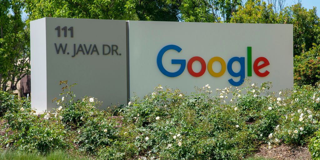 a google sign in front of some bushes and trees